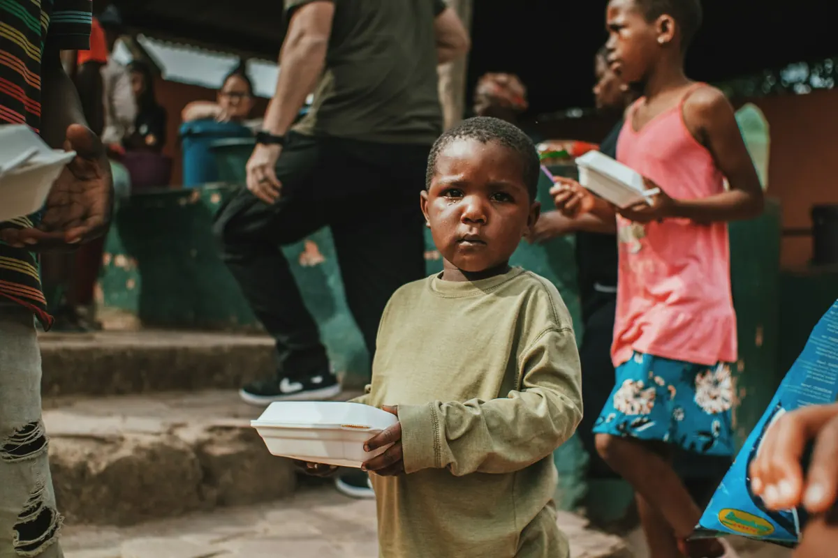 A boy holding a packed meal
