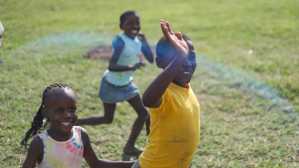 Children running and playing on grass